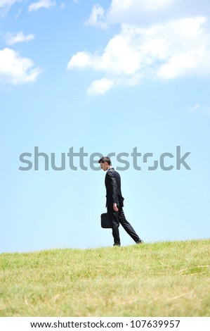 Business man walking in nature