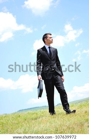 Business man walking in nature