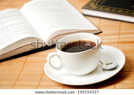 Cup of coffee  with books on table