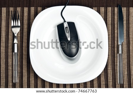 Pc mouse on plate with fork and knife