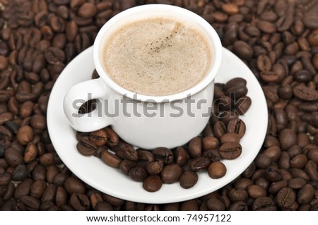 Coffee cup and many beans