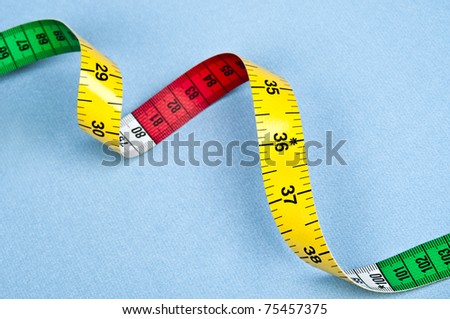 Measurement tape on blue material