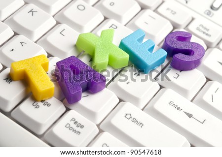 Taxes word made by colorful letters on keyboard