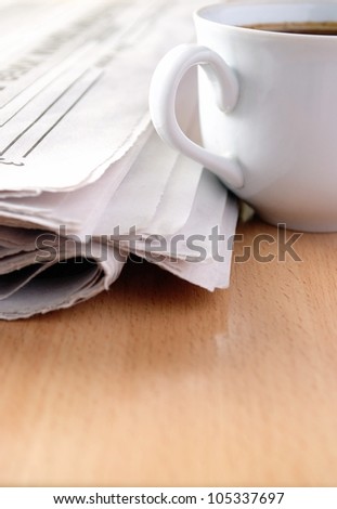 cup of coffee and the newspaper on the table