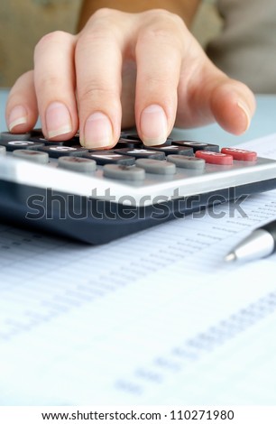 woman doing calculations on a calculator