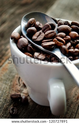 roasted coffee beans in a cup on the table