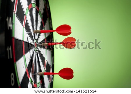arrows darts hit the target and are shown on a green background