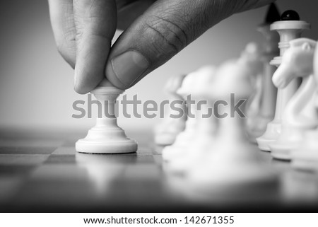 chess game, chess player makes a move the black pawn forward
