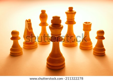 Wooden White Chess Pieces Set on Light Brown Table. Each Piece has corresponding move pattern.