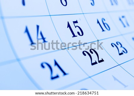 Oblique view of a blank calendar with selective focus to the dates for the 15th and 22nd of the month conceptual of organization, setting a reminder and scheduling