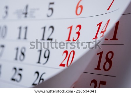Month on a calendar viewd at an oblique angle with selective focus to the dates and numbers