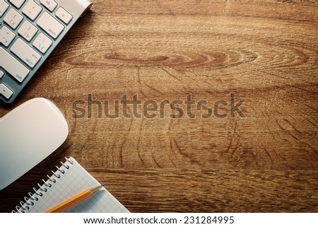 Close up Computer Keyboard and Mouse , Pencil and Graphing Notebook on Top of Wooden Desk with Copy Space .