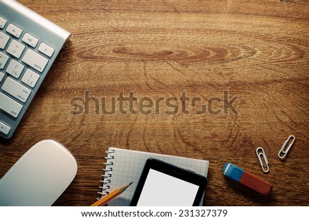 Close up Electronic Devices and School Supplies on Wooden Table, Resting on the Edges, with Central Copy Space for Texts.