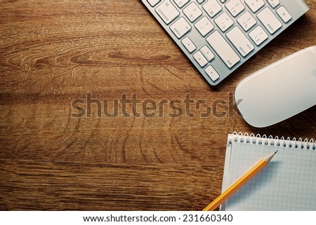 Close up Computer Keyboard and Mouse , Pencil and Graphing Notebook on Top of Wooden Desk with Copy Space on the Left Side.