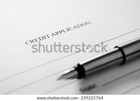 Blank credit application form and fountain pen viewed high angle with focus to the header - Credit Application - in a conceptual image