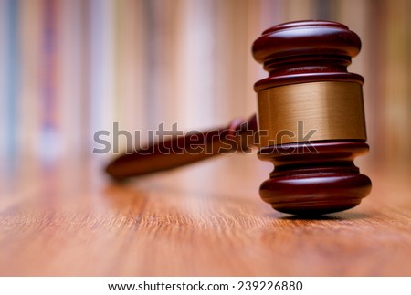 Close up Shiny Wooden Gavel with Gold Plate on Wooden Table. Emphasizing Authority and Right to Act Symbol.