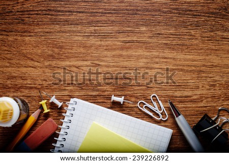 Various Office Supplies on Wooden Table, Captured at the Bottom Edge of the Frame, with Copy Space on Top for Texts.