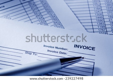 Close up Invoice Documents and Pen on Top of Table, Emphasizing Invoice Number and Date.
