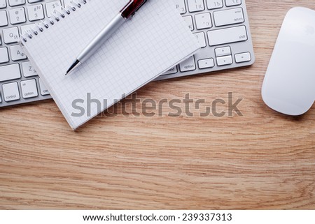 Conceptual Ballpoint Pen and White Computer Keyboard and Mouse of Wooden Table with Copy Space.