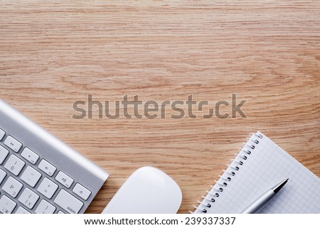 Conceptual Ballpoint Pen and White Computer Keyboard and Mouse of Wooden Table with Copy Space.