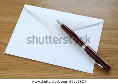 Mailing envelope and a pen on the table