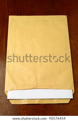 Open the yellow mailing envelope with a piece of paper