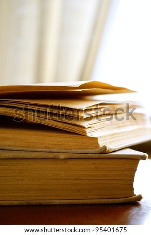 Light window, curtain and two books on a table