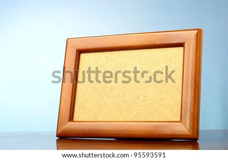 wooden photo frame on a blue background