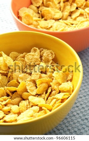 yellow and orange bowls with corn flakes