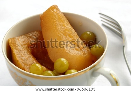 canned pears in a bowl and fork on the table