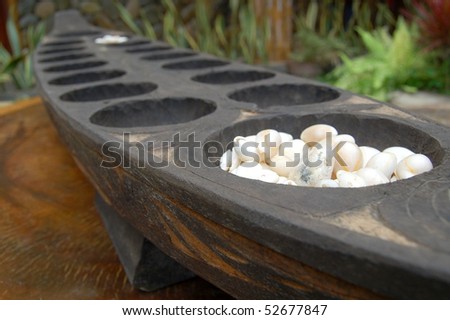 A Philippine mancala game. In the Philippines a variant is called \