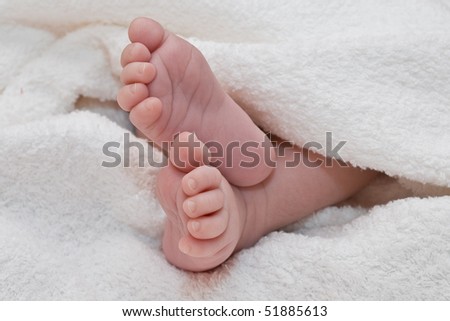 White towel around cute newborn feet