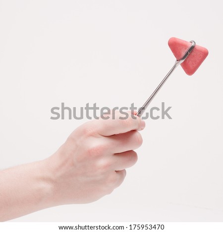 Hand holding reflex hammer.