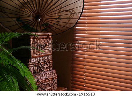 house interior with chinese umbrella and 3 wicker boxes