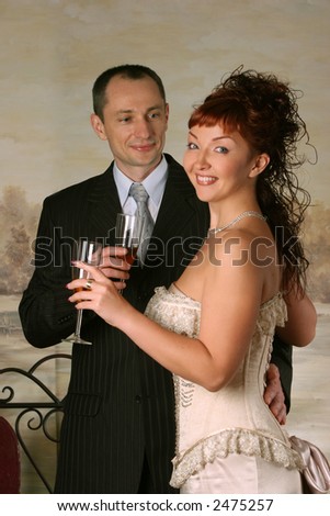 man in suit and beautiful woman drinking wine