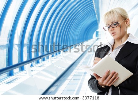 woman in suit reading organizer on the hi-tech background