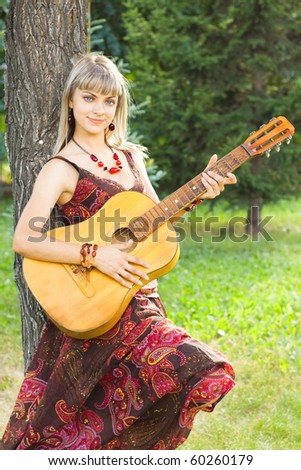 girl plays the guitar, stringed instruments, smiling