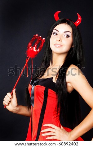 Beautiful  skinny girl devil holds the magic wand