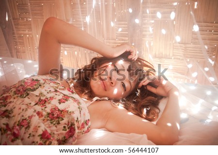 Asian women on bed in a romantic atmosphere.