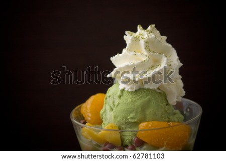 fruit ice cream with raw fruits on black background.