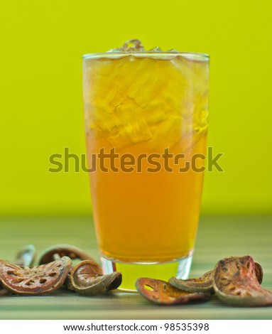 Herb drink Bale juice on yellow background.