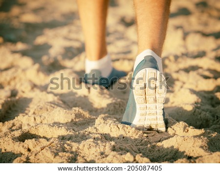 runner running on a empty beach