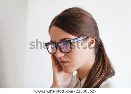 Serious young woman wearing cool glasses