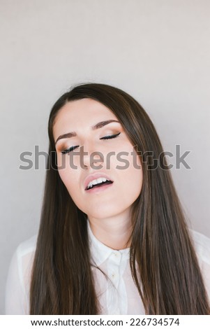 young brunette woman yawns