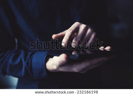 tablet in the hands of a young guy