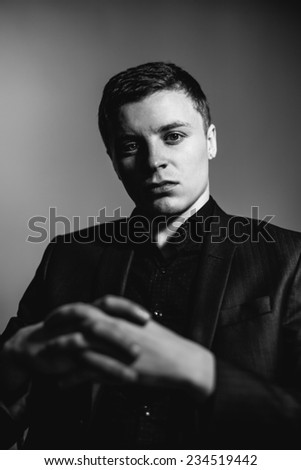 Young man's face. Close-up portrait. Black-white photo.