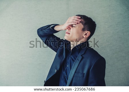 Worried businessman with hand on the head