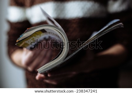Portrait of young handsome guy holding a journal