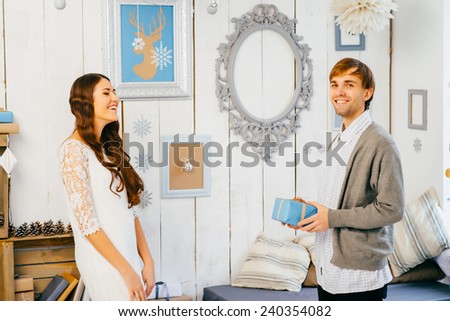 Young woman delighted to receive a prettily wrapped Christmas present