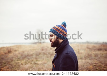 a young man with a beard in nature